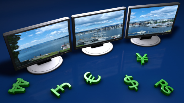 three monitors with currency signs